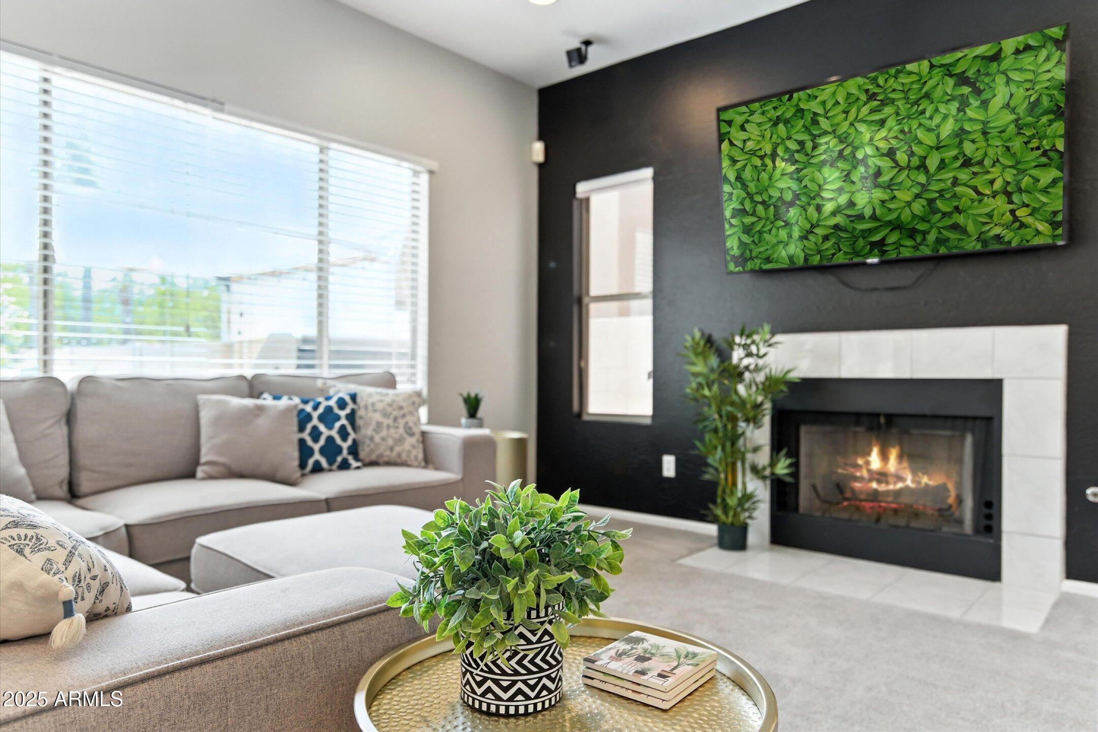 8083 East Michelle Drive Scottsdale, AZ 85255 - Photo 7 of 40 a living room with furniture a fireplace and a large window