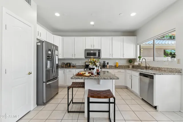 a kitchen with a refrigerator and a stove top oven