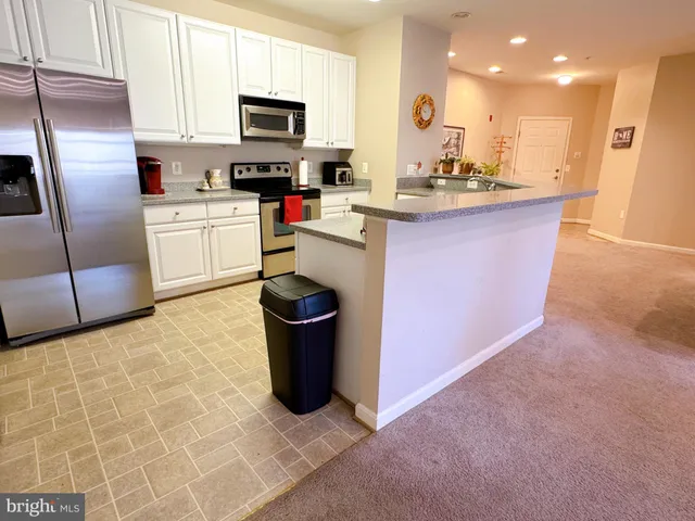 an empty room with wall painting and windows