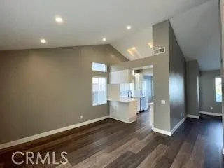 a view of kitchen with wooden floor and electronic appliances