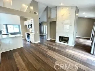 a view of a kitchen with a sink cabinets and a fireplace