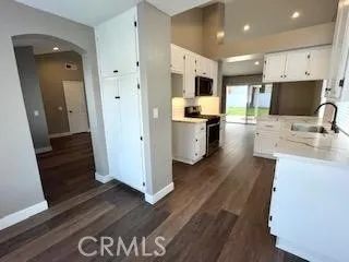 a kitchen with stainless steel appliances a refrigerator sink and microwave