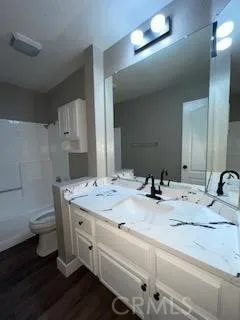 a bathroom with a double vanity sink and a mirror