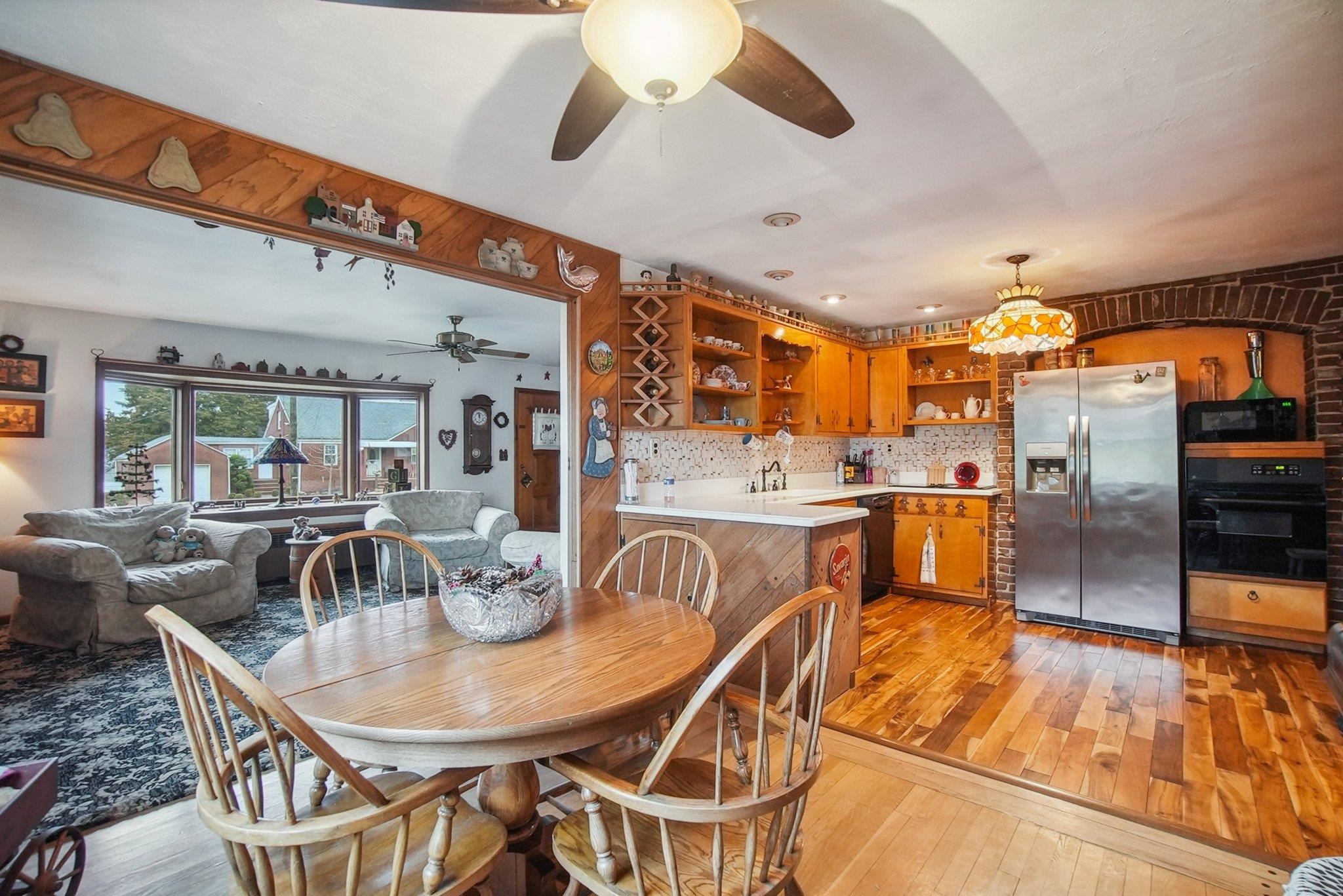 42 Frederick Street Carteret, NJ 07008 - Photo 4 of 15 a dining room with stainless steel appliances kitchen island granite countertop a table chairs and a view of living room