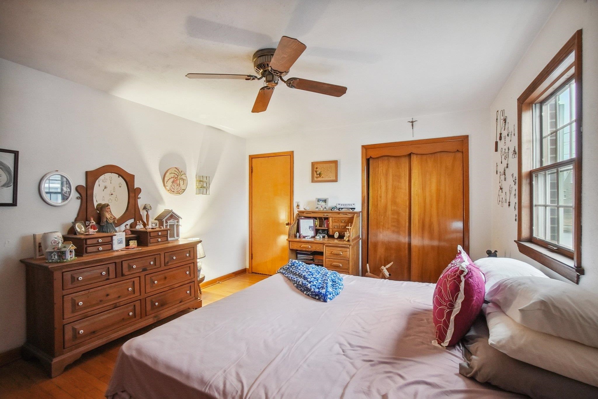 42 Frederick Street Carteret, NJ 07008 - Photo 7 of 15 a bedroom with a bed and wooden floor