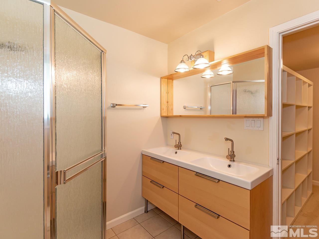22870 Carriage Drive Reno, NV 89521 - Photo 11 of 16 a bathroom with a sink and mirror