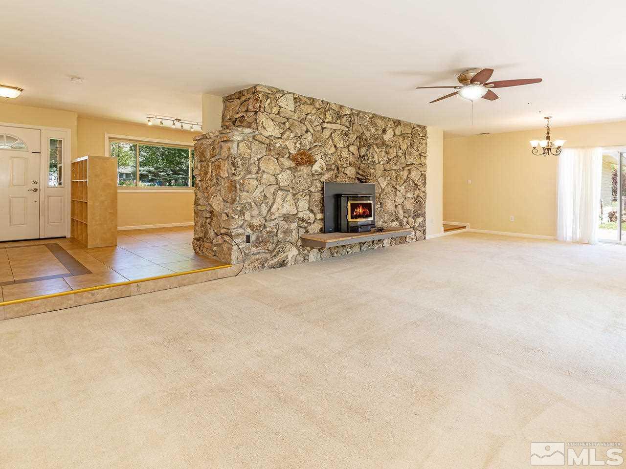 22870 Carriage Drive Reno, NV 89521 - Photo 6 of 16 en empty room with windows and fireplace