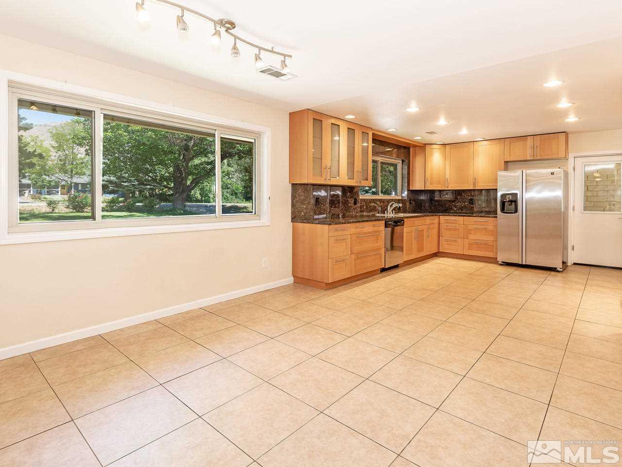 22870 Carriage Drive Reno, NV 89521 - Photo 8 of 16 a large kitchen with stainless steel appliances granite countertop a refrigerator and a stove top oven