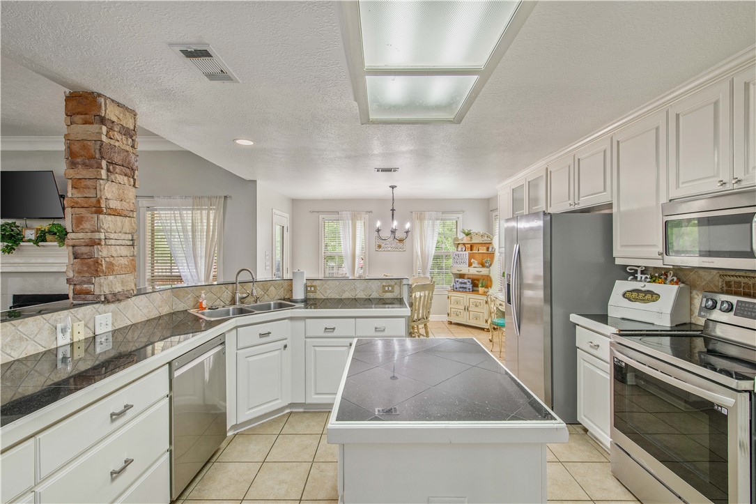 6538 Olympia Buddy Road College Station, TX 77845 - Photo 19 of 50 a kitchen with a sink stainless steel appliances and cabinets