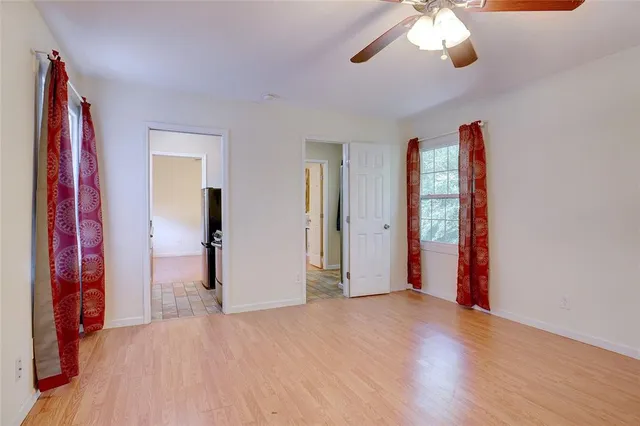 a view of a room with wooden floor and entryway