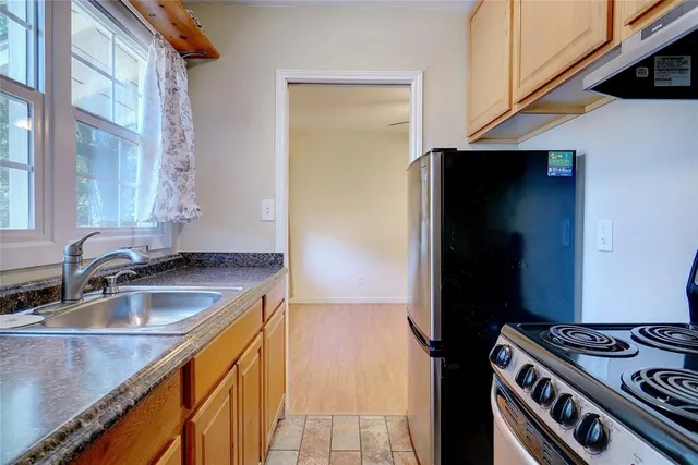 a kitchen that has a sink and a stove