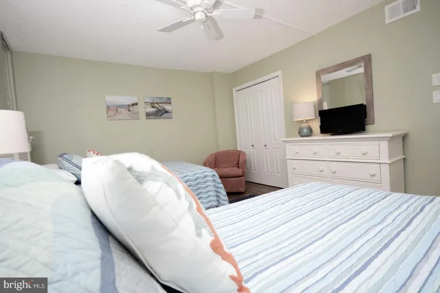 a bedroom with a large bed and a flat screen tv