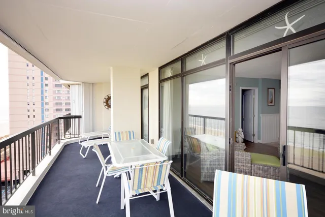 a view of a hallway with wooden floor and windows
