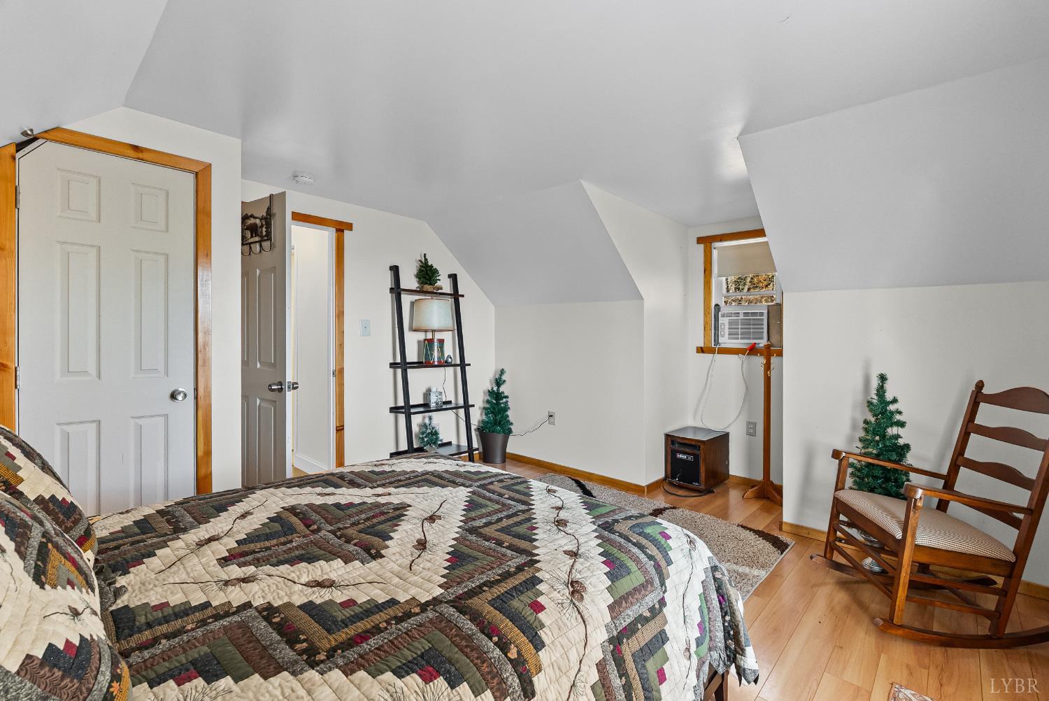 371 Hawks Nest Road Monroe, VA 24574 - Photo 24 of 51 a bedroom with a bed and a chair with the wooden floor
