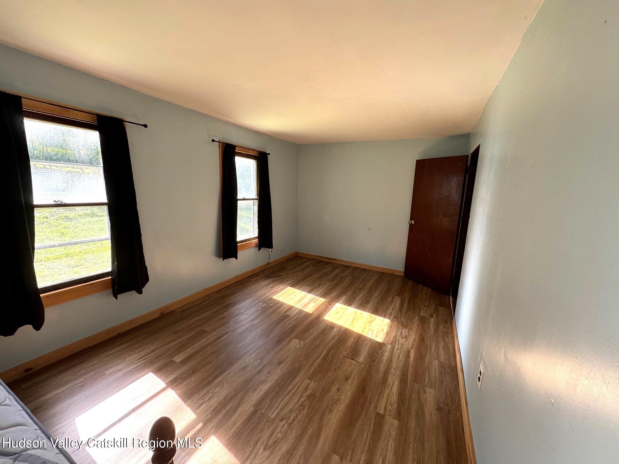 573 Manorville Road Saugerties, NY 12477 - Photo 11 of 16 wooden floor in an empty room with a window