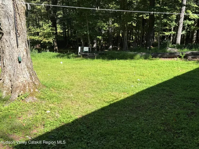 a view of a house with a yard and a garden