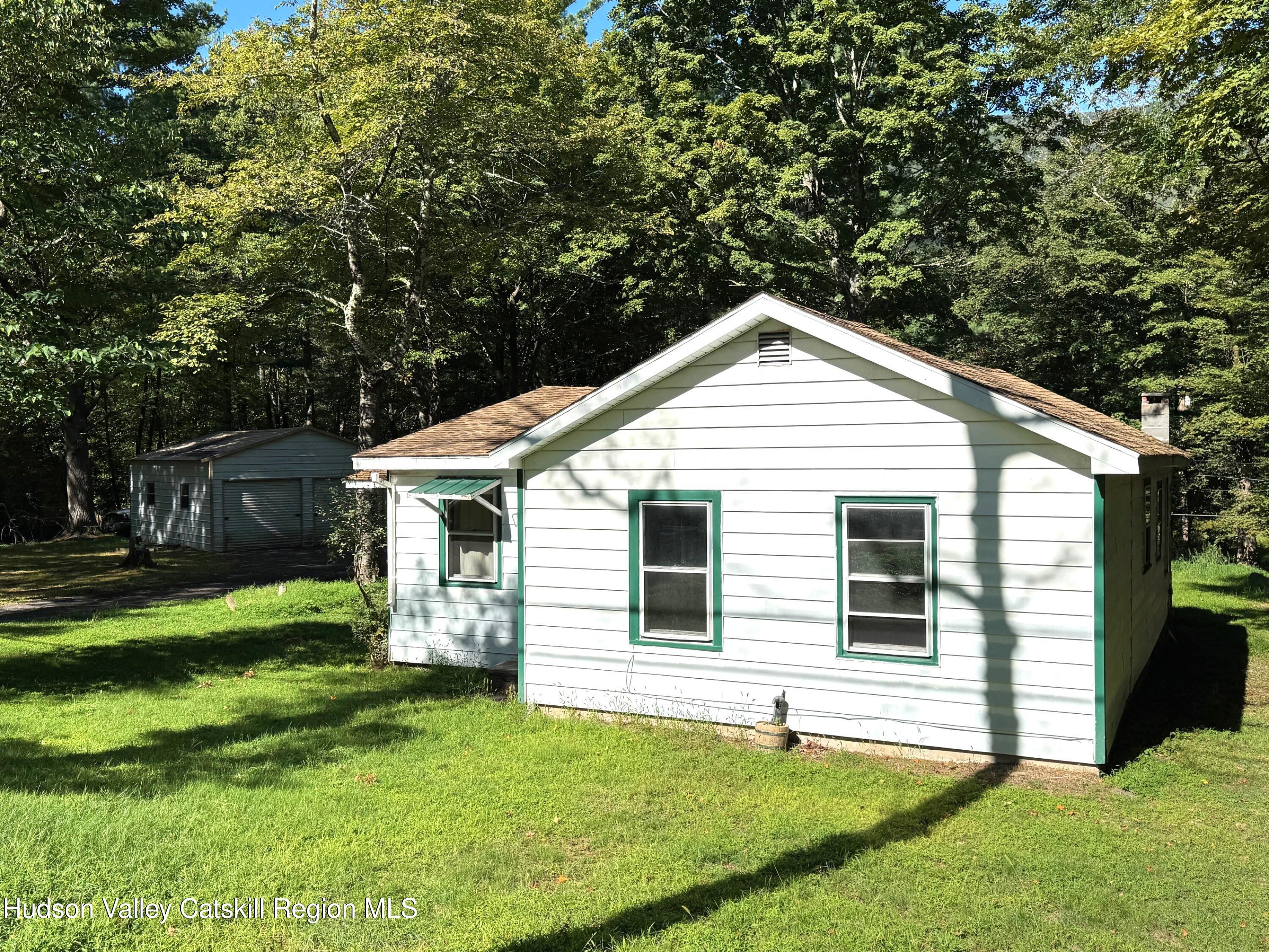 573 Manorville Road Saugerties, NY 12477 - Photo 14 of 16 a view of a house with a yard and a garden