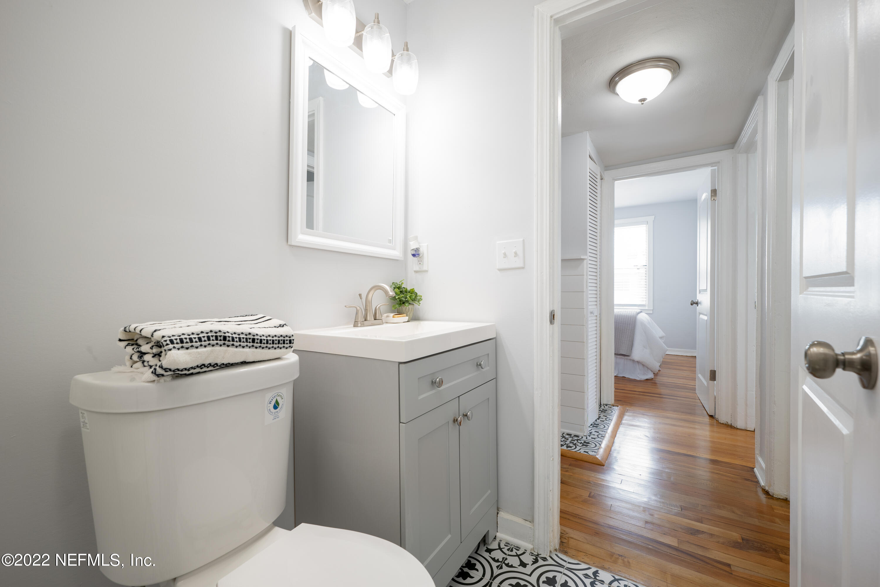 1368 Rensselaer Avenue Jacksonville, FL 32205 - Photo 12 of 48 a bathroom with a sink a toilet and a mirror