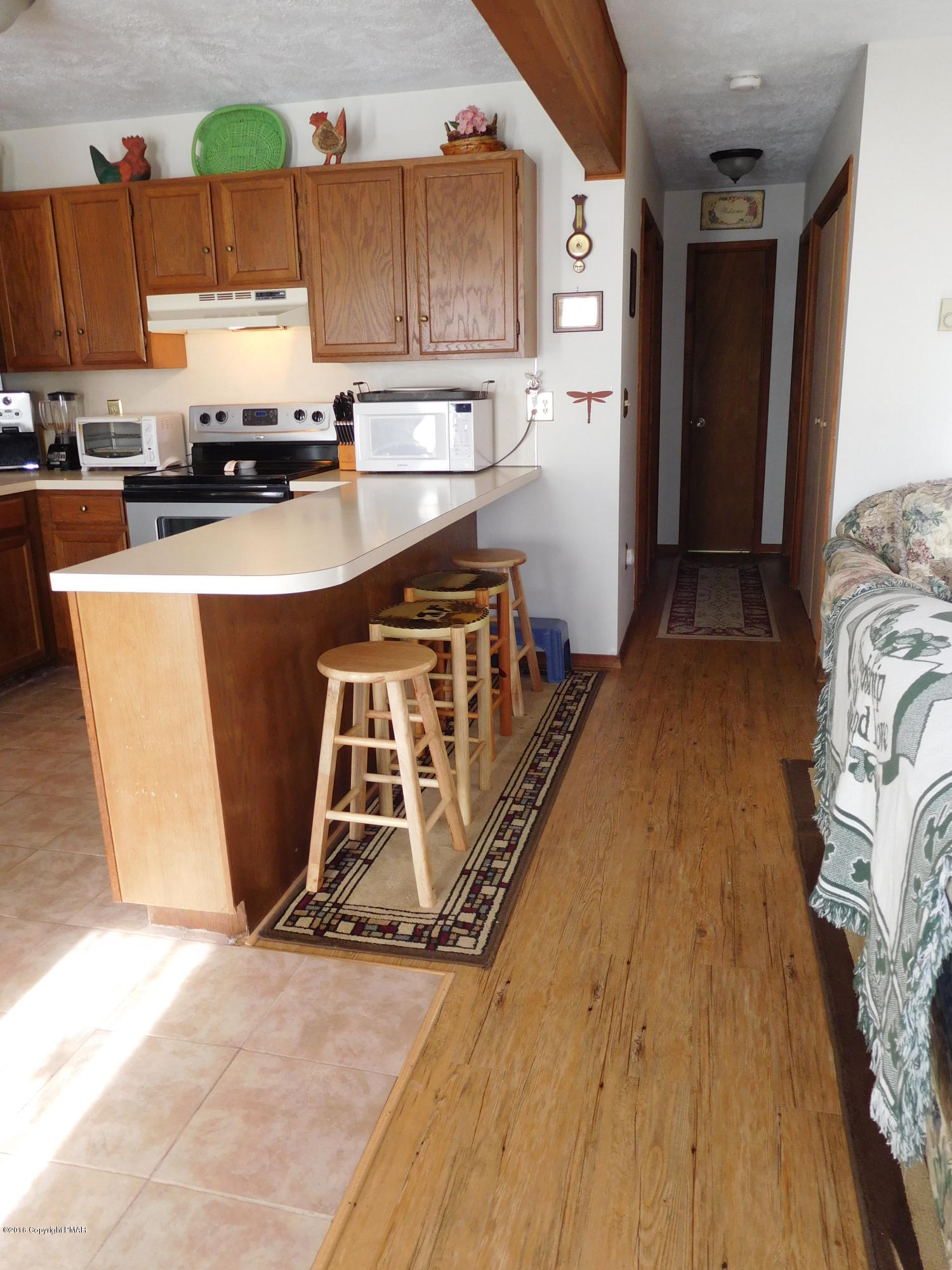 153 Maple Road Blakeslee, PA 18610 - Photo 11 of 32 a kitchen with stainless steel appliances granite countertop a stove a refrigerator a sink and dishwasher
