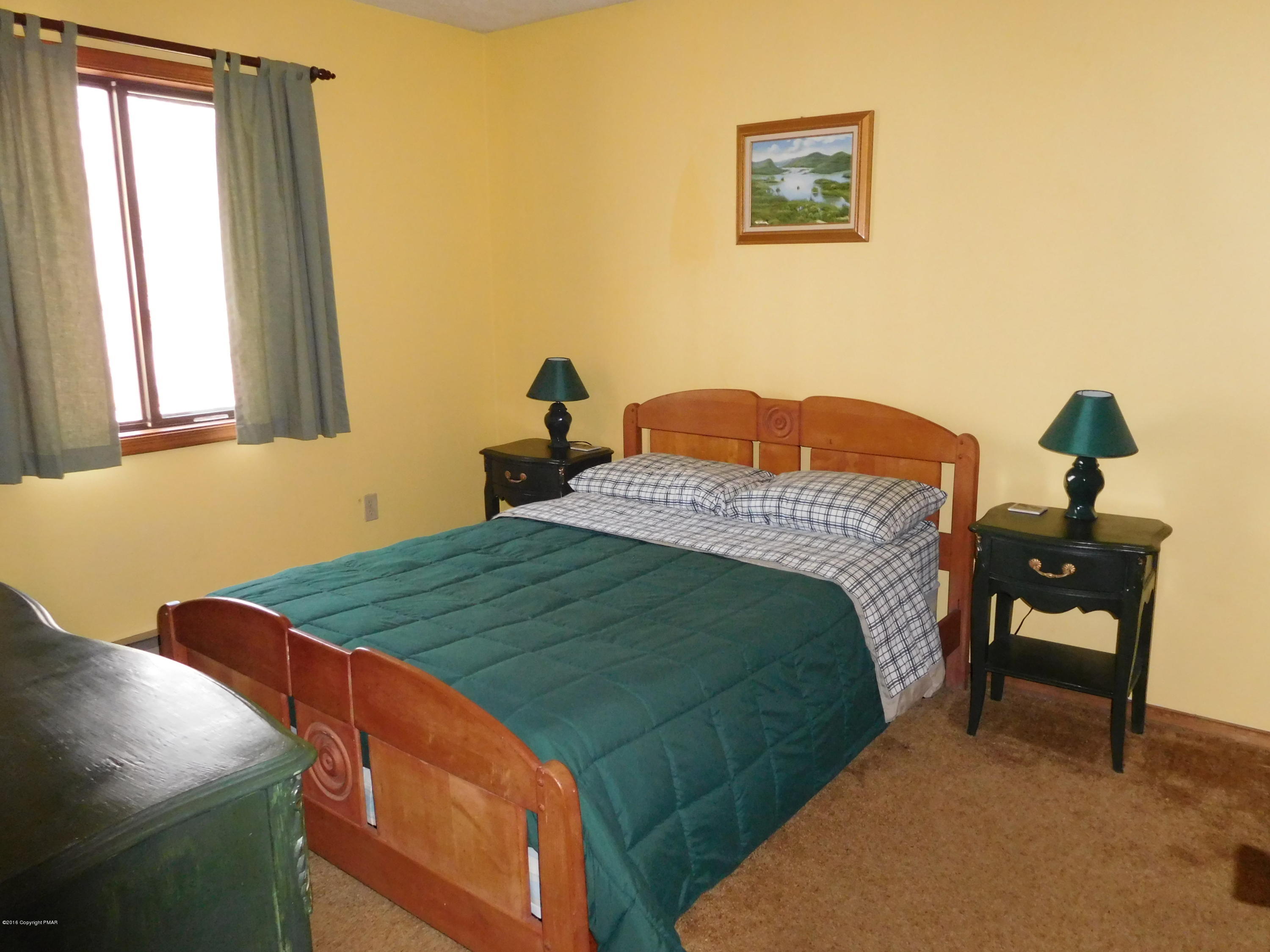 153 Maple Road Blakeslee, PA 18610 - Photo 14 of 32 a bedroom with a bed and a window