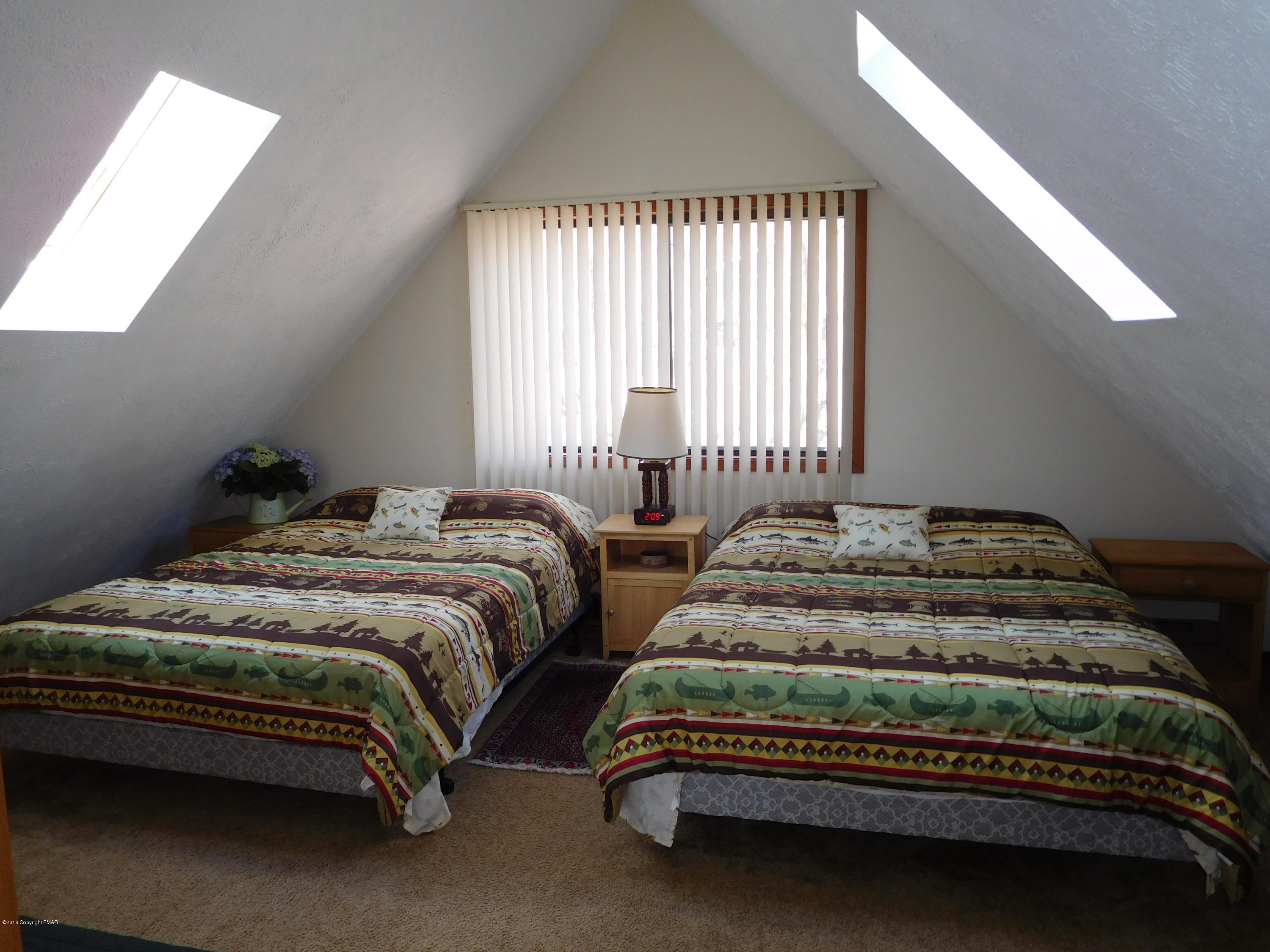 153 Maple Road Blakeslee, PA 18610 - Photo 16 of 32 a bedroom with two beds and a window
