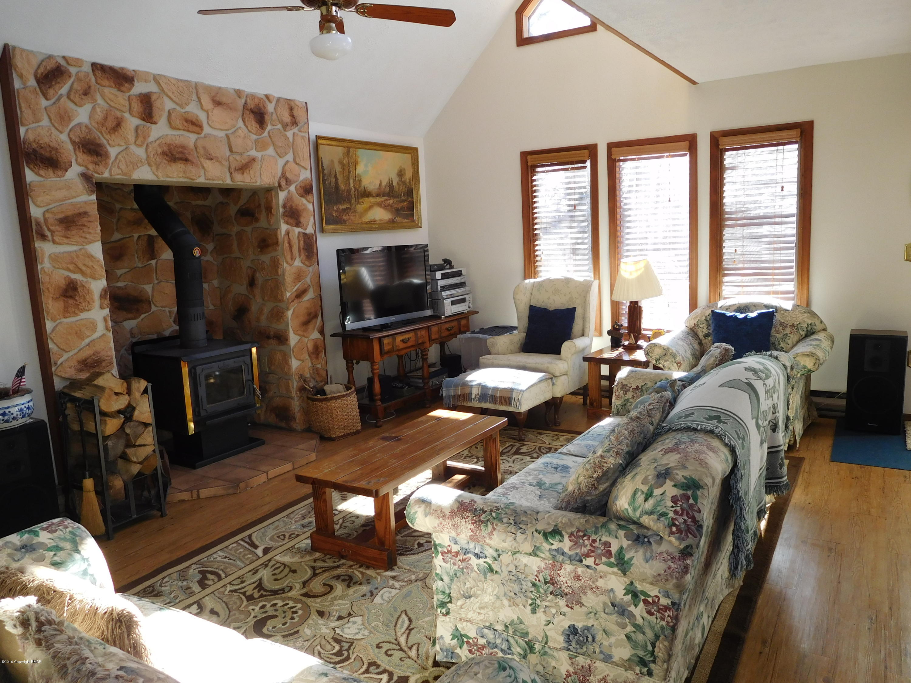 153 Maple Road Blakeslee, PA 18610 - Photo 6 of 32 a living room with furniture a window and a flat screen tv