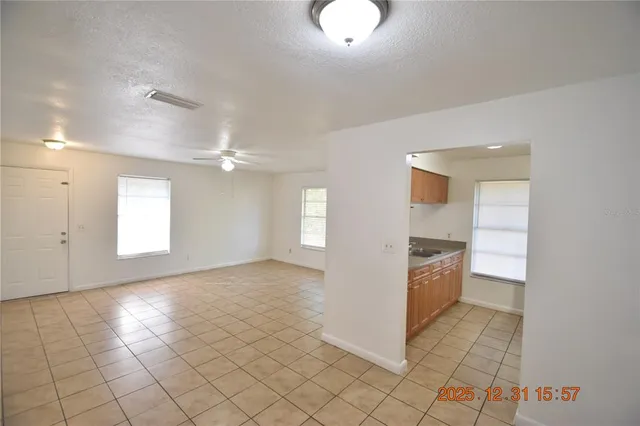 a view of a kitchen with a sink and dishwasher a oven with wooden cabinets