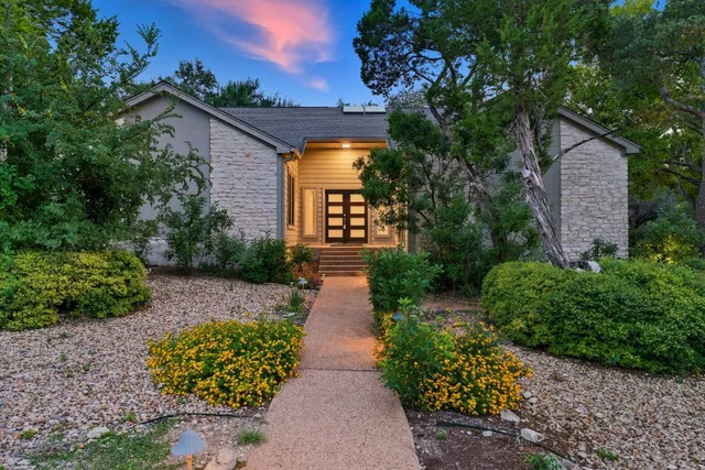 a front view of a house with garden