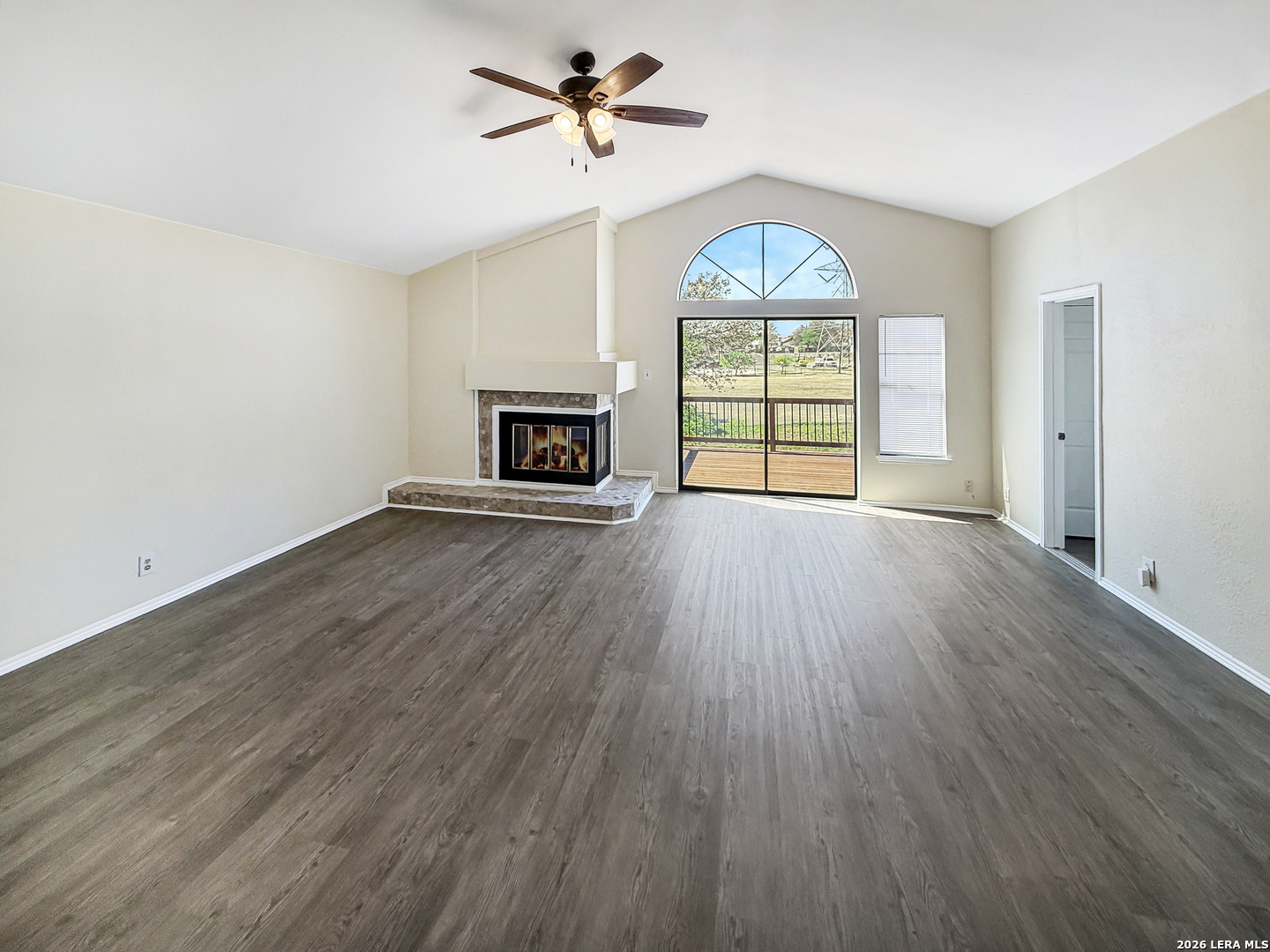 9808 Delta Ridge Drive Converse, TX 78109 - Photo 12 of 38 an empty room with windows fireplace and wooden floor