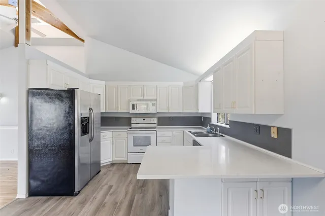 a kitchen with stainless steel appliances a refrigerator sink and cabinets