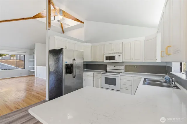 a kitchen with stainless steel appliances a refrigerator sink and stove