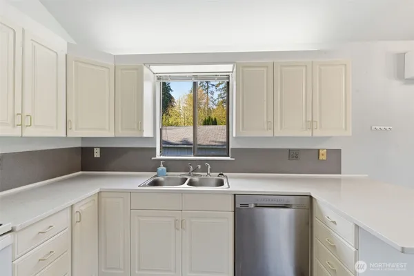 a kitchen with a sink cabinets and window