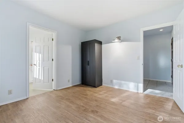 a bedroom with a bed and a painting on the wall