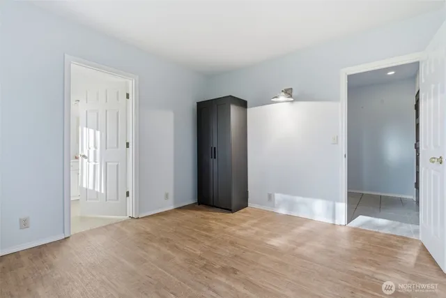 a bedroom with a bed and a painting on the wall