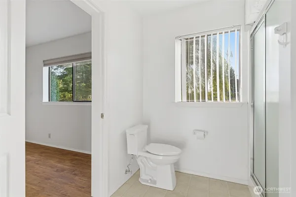 a bathroom with a granite countertop sink a mirror and a shower