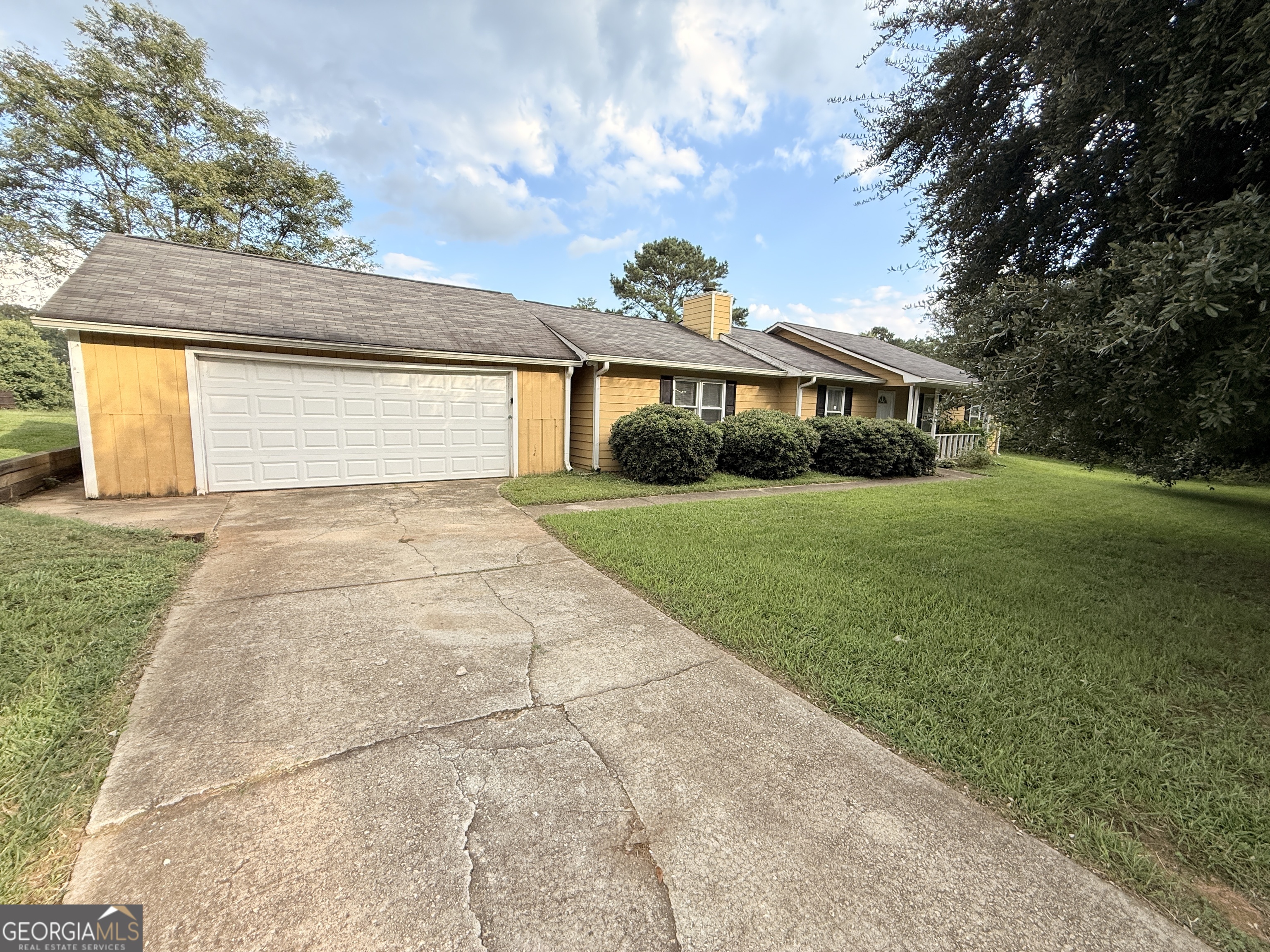 a front view of house with yard and green space