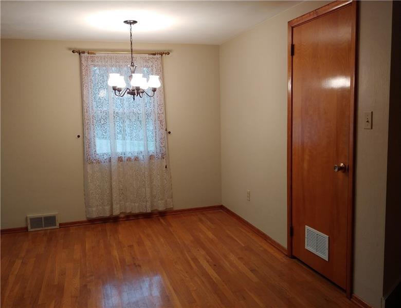 356 Middletown Road New Stanton, PA 15672 - Photo 5 of 15 The dining room opens to the kitchen and living room. The door on the right leads to the lower level and you get a beautiful view of the backyard from the window.