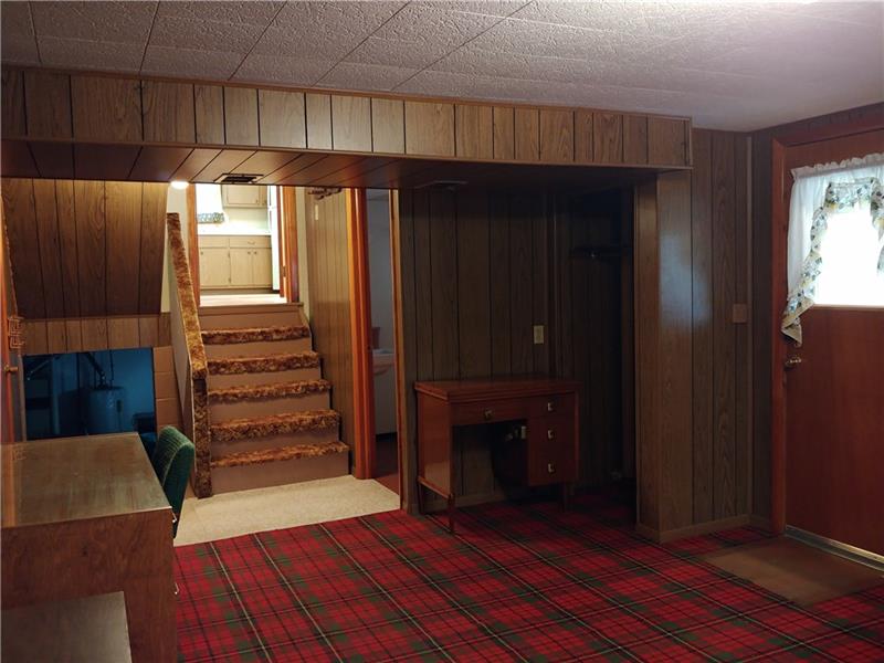 356 Middletown Road New Stanton, PA 15672 - Photo 10 of 15 View from Family Room with stairs directly ahead leading to main level. Opening to the left is stairs leading to basement. Full bath is on the right and door to the immediate right leads to the covered patio.