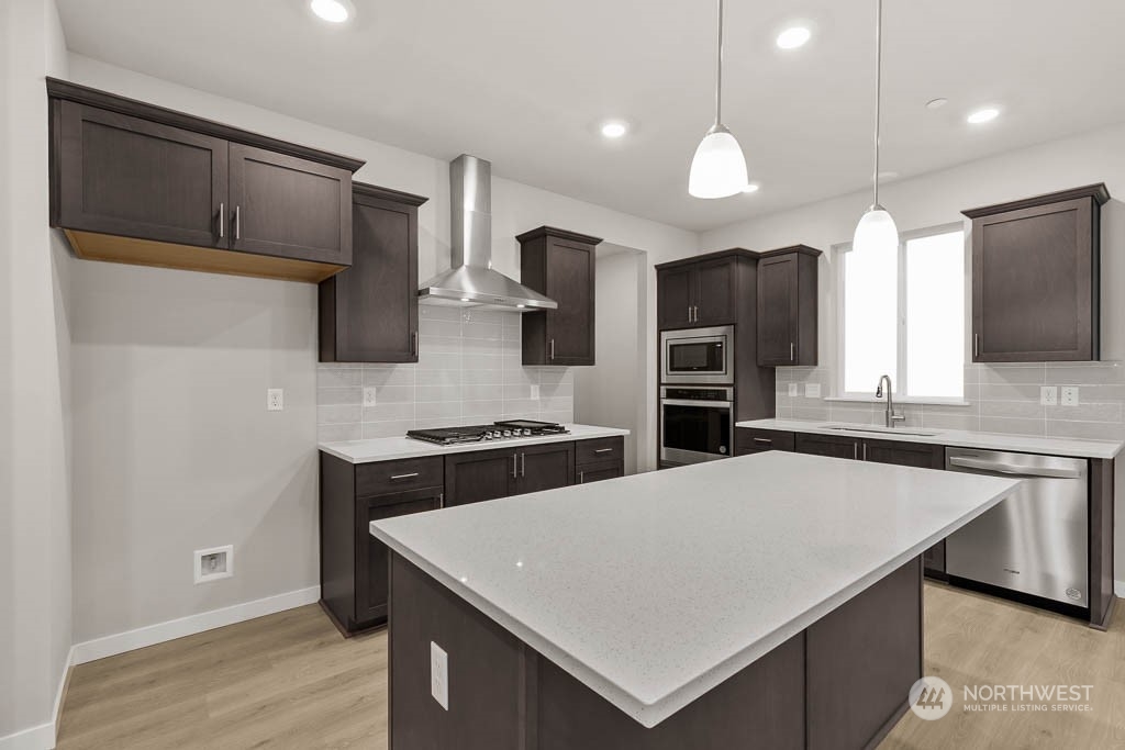 2725 193rd Place Southeast, Unit F6 Bothell, WA 98012 - Photo 15 of 35 a kitchen with stainless steel appliances a stove sink microwave and cabinets