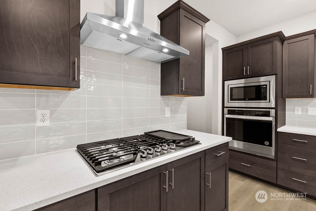 2725 193rd Place Southeast, Unit F6 Bothell, WA 98012 - Photo 16 of 35 a kitchen with cabinets and steel stove