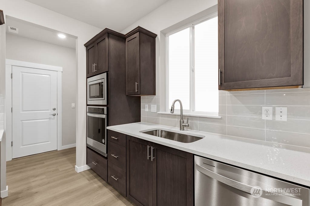 2725 193rd Place Southeast, Unit F6 Bothell, WA 98012 - Photo 17 of 35 a kitchen with a sink and a refrigerator