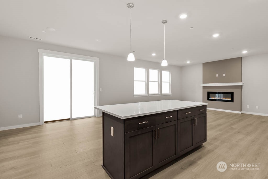 2725 193rd Place Southeast, Unit F6 Bothell, WA 98012 - Photo 18 of 35 a kitchen with a wooden floor and a fireplace