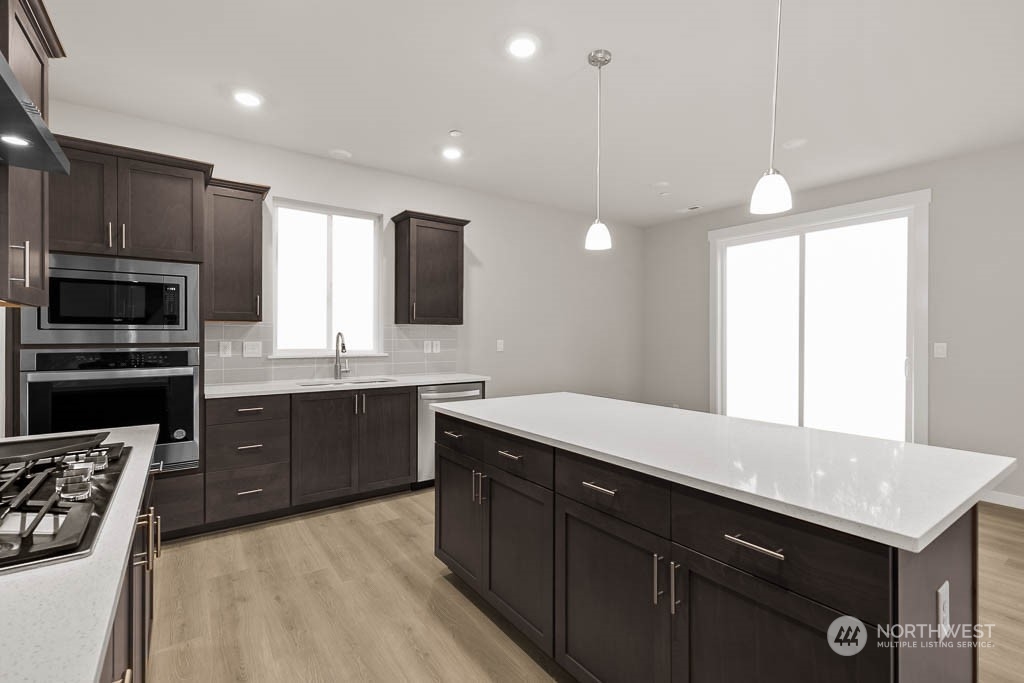 2725 193rd Place Southeast, Unit F6 Bothell, WA 98012 - Photo 19 of 35 a kitchen with a sink appliances and cabinets