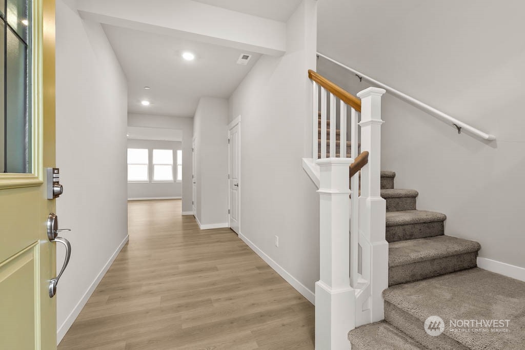 2725 193rd Place Southeast, Unit F6 Bothell, WA 98012 - Photo 2 of 35 a view of entryway and hall with wooden floor