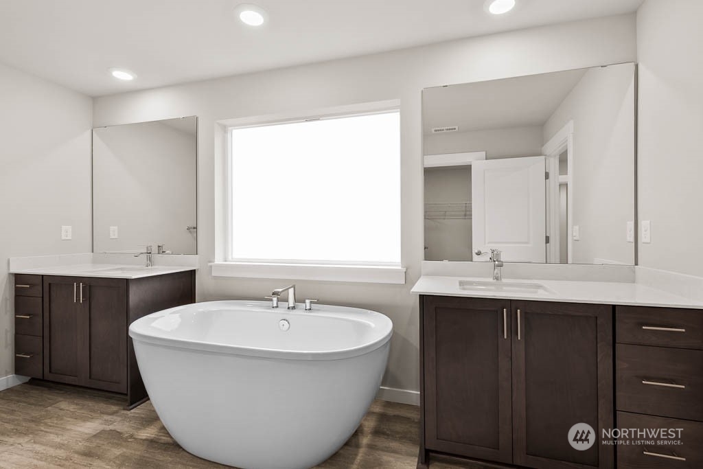 2725 193rd Place Southeast, Unit F6 Bothell, WA 98012 - Photo 27 of 35 a bathroom with a double vanity sink and a mirror