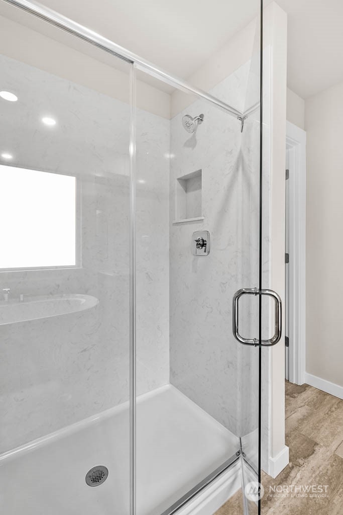 2725 193rd Place Southeast, Unit F6 Bothell, WA 98012 - Photo 29 of 35 a bathroom with a shower and a glass door