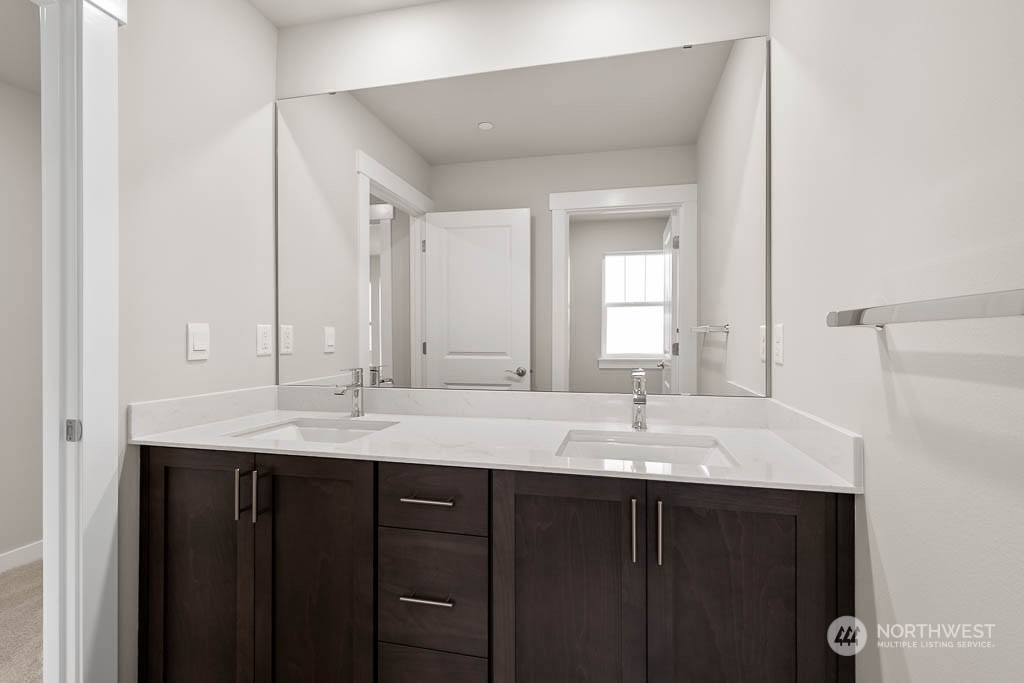 2725 193rd Place Southeast, Unit F6 Bothell, WA 98012 - Photo 32 of 35 a bathroom with a granite countertop sink and a mirror