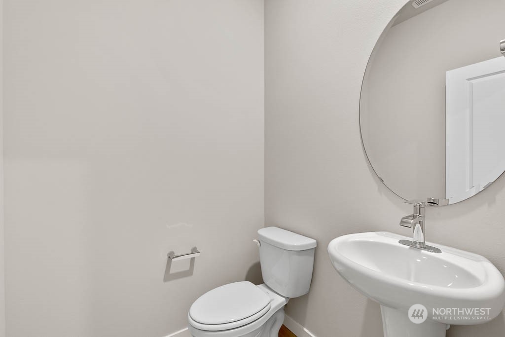 2725 193rd Place Southeast, Unit F6 Bothell, WA 98012 - Photo 6 of 35 a bathroom with a sink a toilet and mirror