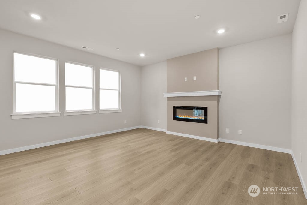 2725 193rd Place Southeast, Unit F6 Bothell, WA 98012 - Photo 8 of 35 an empty room with a fireplace and window