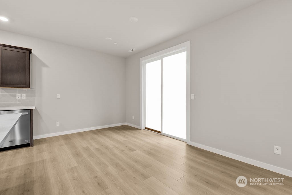 2725 193rd Place Southeast, Unit F6 Bothell, WA 98012 - Photo 10 of 35 a view of an empty room with a fireplace and a flat screen tv